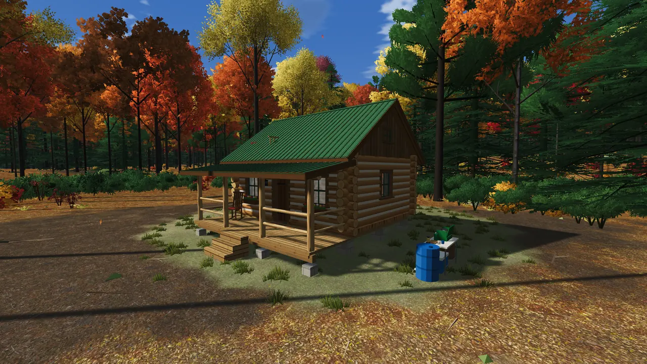 The finished log cabin with a green metal roof and porch among fall trees