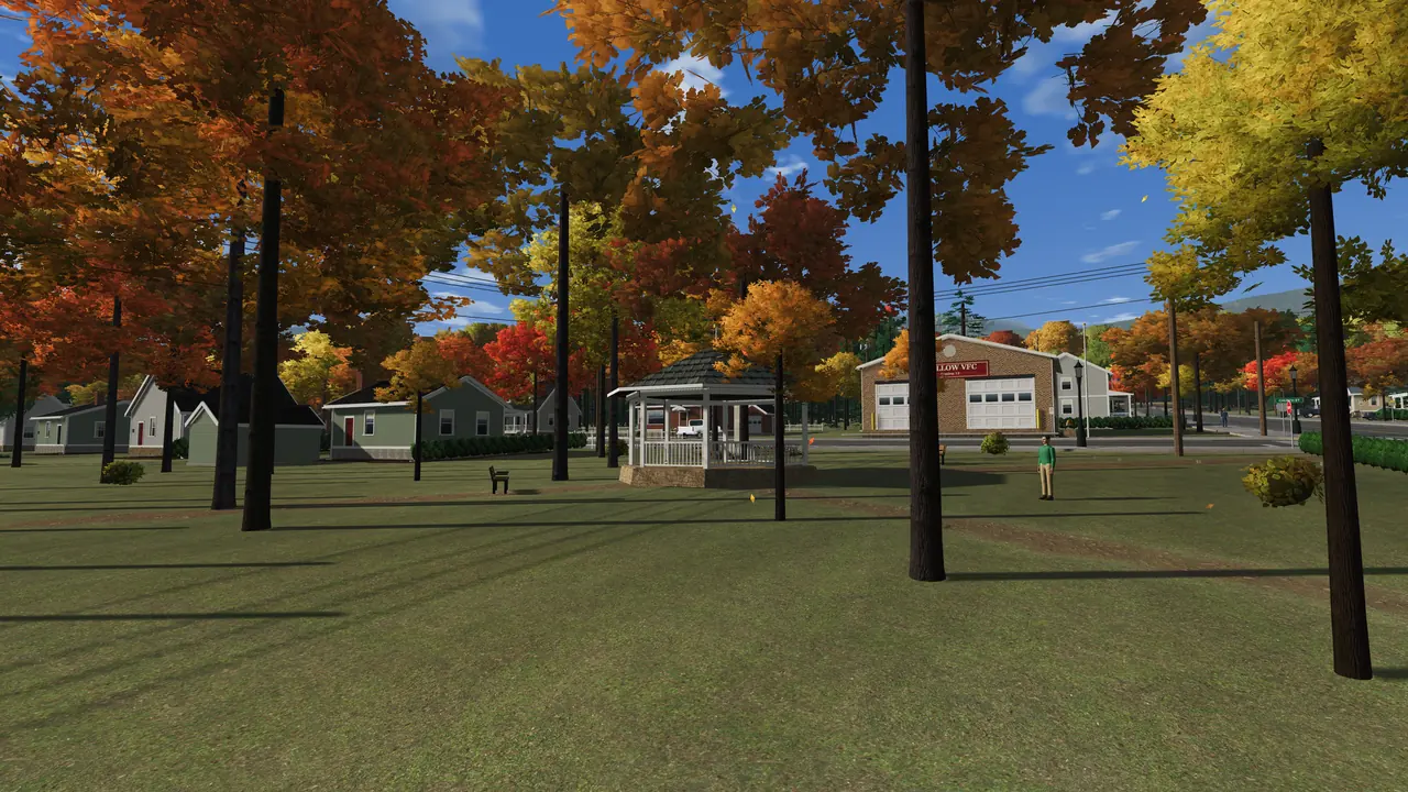 The town green in fall: the gazebo among orange trees, with the fire hall behind